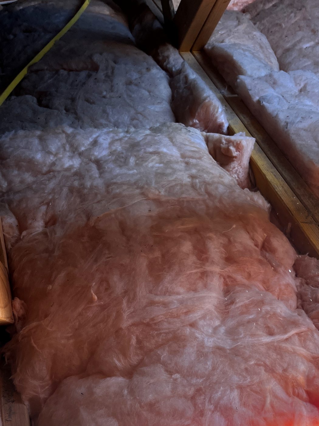 The same roof space with the insulation batts laid back over the ceiling after the fan cable was run, by SALTD Electrical